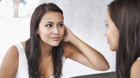 Woman checking her skin in the mirror